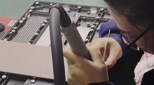 A technician inspects tiny pixels