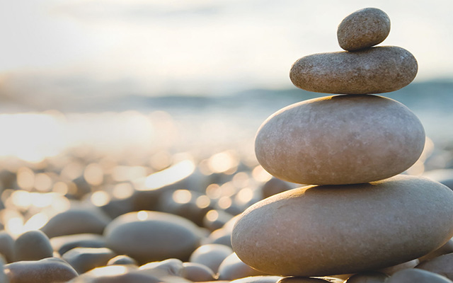 a stack of pebbles representing reliability and sustainability with the words ‘A Lasting Vision’