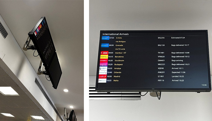 two ceiling mounted screens show flight information