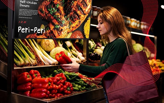 A digital screen shows a recipe as a woman chooses ingredients