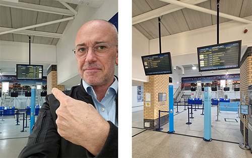 A man points at a flight information display in an airport